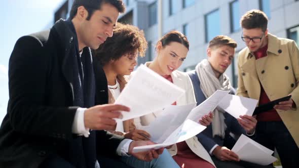 International Business Team with Papers Outdoors