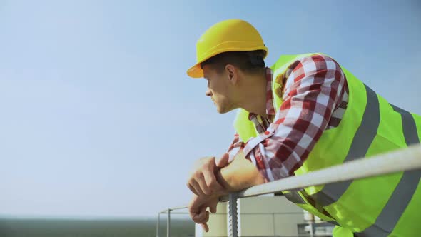 Young Worker Leaning Building Rails Standing Outdoors, Construction Occupation