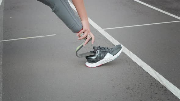 Disabled Athlete Stretching Legs on Track. Lady Warming Legs Before Workout