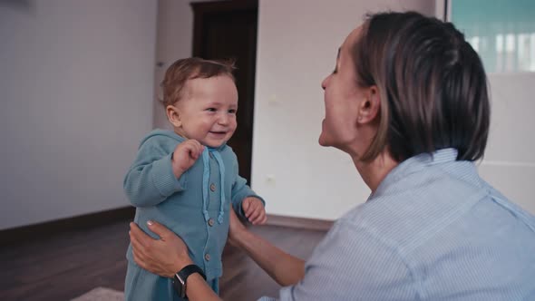 Mother and Her Baby Son Having Fun and Playing at Home