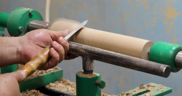 Closeup of carpenter turning wood on a lathe