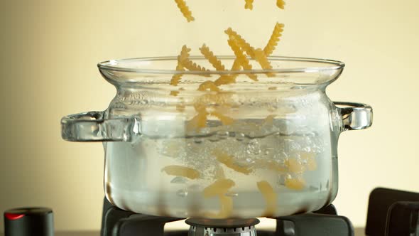 Super Slow Motion Shot of Fresh Fusilli Falling Into Boiling Salted Water at 1000 Fps.