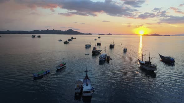 fishing boats at sea in the sunset