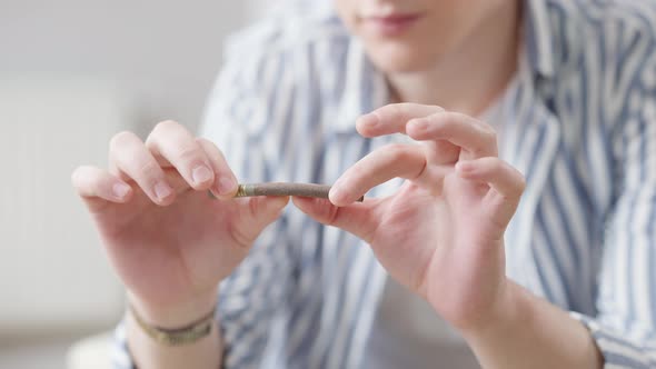 Closeup of Male Hands Breaking Cigar