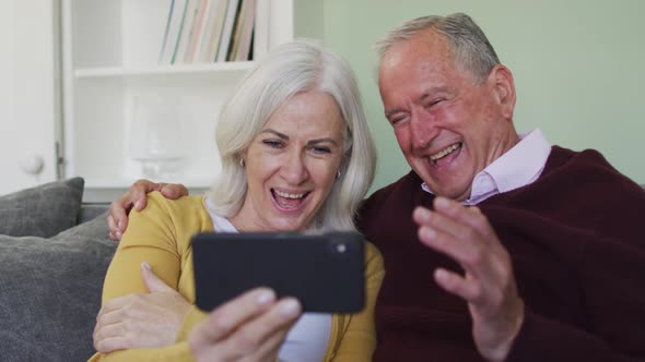 Happy senior caucasian couple making video call using laptop computer