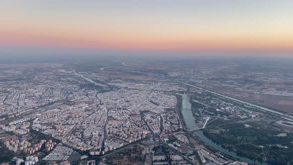 Stunning aerial view of Seville, (Sevilla city), Spain, from a jet cockpit taken at sunset, with a b