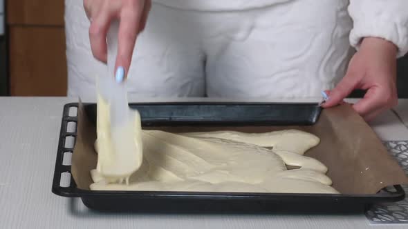 A Woman Smoothes The Dough On A Baking Sheet. Cooking Biscuit Cake Dairy Girl.