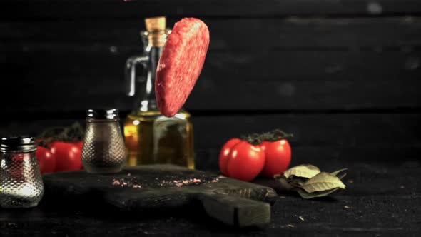 Super Slow Motion on the Cutting Board Falls Raw Burger