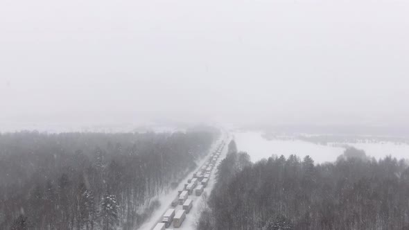 Trucks are Stuck in Traffic on a Snowcovered Highway