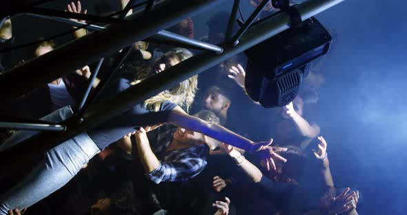 Crowd surfing at a concert 4k