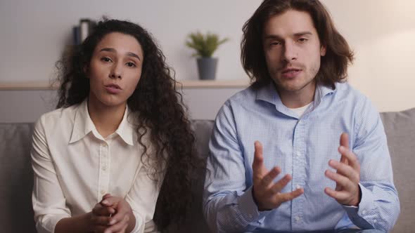 Young Emotional Caucasian Spouses Talking to Camera Sharing with Relationship and Marriage Problems