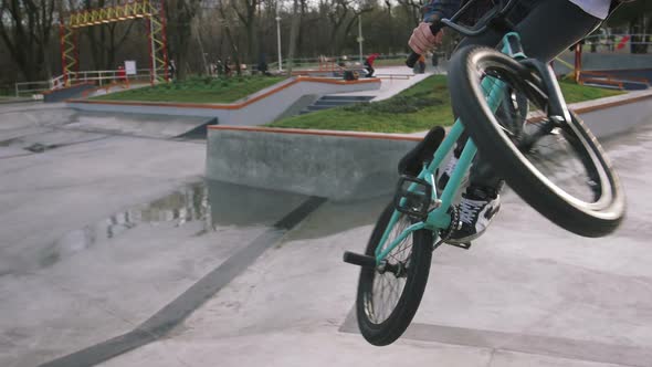 BMX Rider Doing Tricks in Street Plaza Bicycle Stunt Rider in Cocncrete Skatepark Super Slow Motion