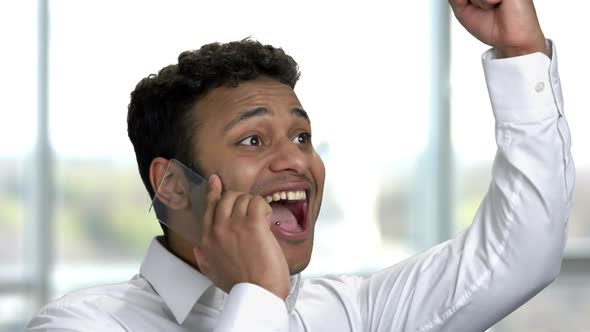 Portrait Exremely Happy Young Indian Man Talking on Copyspace Phone