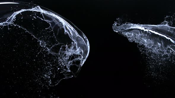 Super Slow Motion Shot of Water Splashes Crashing on Black Background at 1000Fps alt