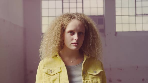 Fashionable young woman in an abandoned warehouse