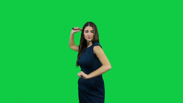 Girl discourages and threaten with telescopic bat in front of a green screen