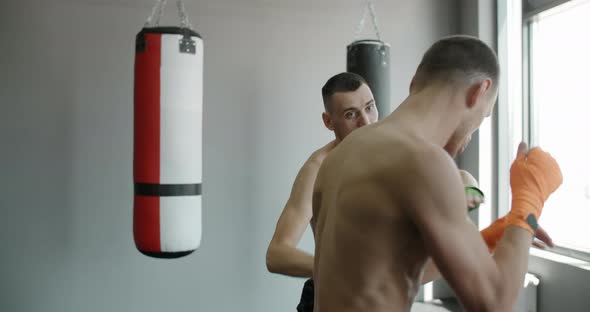 Mixed Martial Arts Fighters are Practising Their Strikes Kicks and Punches in Slow Motion in the Gym