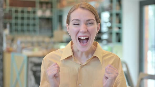 Portrait of Excited Young Woman Celebrating Success