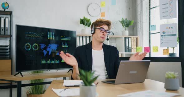 Smart Caucasian Guy Using Headphones Video Call Communicate with Business colleague