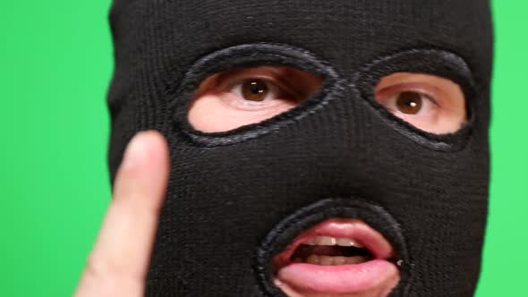 Scary Thief or Robber in Mask Looking at Camera