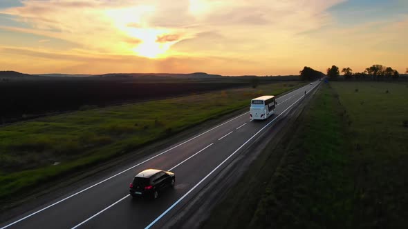 Aerial Drone View White Tourist Bus Driving Away for a Journey