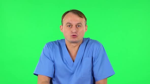 Displeased Man Indignantly Talking To Someone, Looking at the Camera. Green Screen