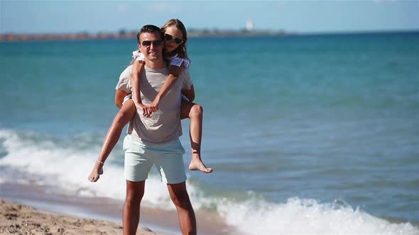 Little Girl and Happy Dad Having Fun During Beach Vacation