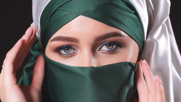 Close-up Asian Muslim Woman with Hijab Traditional Veil Isolated Over Black Background