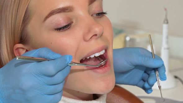 Attractive Woman with Perfect White Healthy Teeth Having Oral Checkup