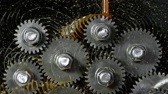 Super Slow Motion Shot of Gear Mechanism and Oil on Dark Background at 1000 Fps