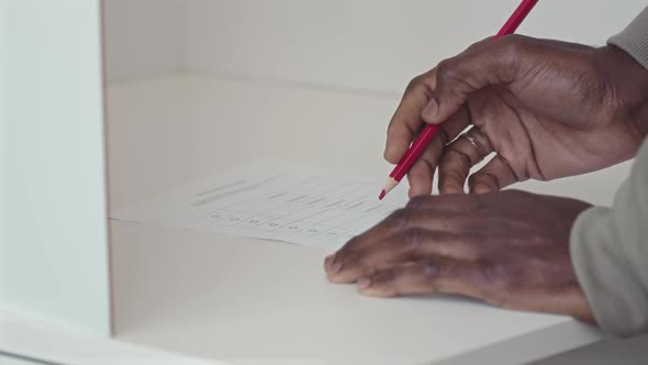 Black Man Putting Tick in Ballot Vote