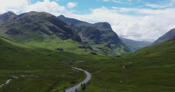 Glen Coe and Three Sisters with A82 road, aerial, drone