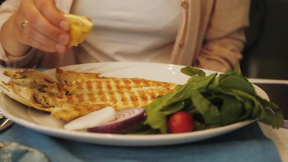 Grilled Tasty White Fish on White Plate with Vegetables