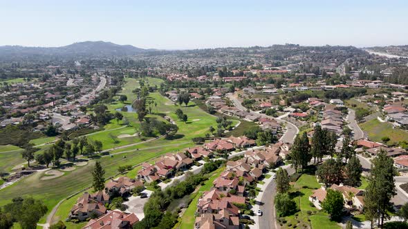 Aerial View of Residential Neighborhood Surrounded By Golf and Valley During Sunny Day in Rancho