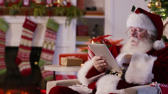 Santa Claus using digital tablet alt