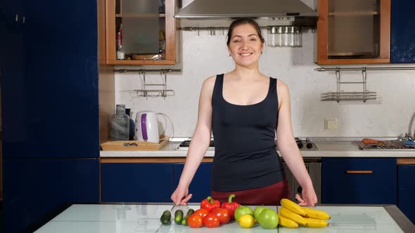 Girl Shows Thumb Up Standing Near Fresh Vegetables and Fruit