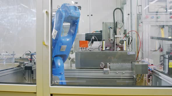 Robotic line at a manufacturing facility. Robot placing metal parts