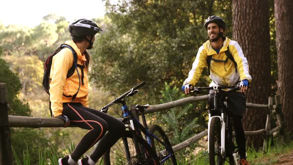 Mountain biker couple taking a break while biking