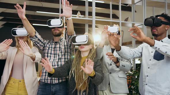 Young Mixed Race Office Friends which Working on Interactive Screen in Virtual Reality Headset