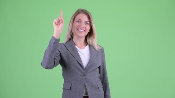 Happy Young Beautiful Blonde Businesswoman Pointing Up