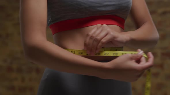 Woman measuring her waist