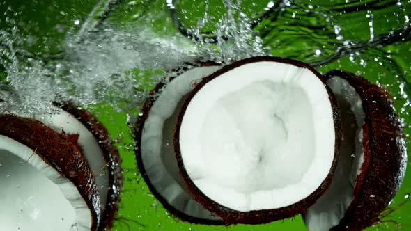 Super Slow Motion Shot of Flying Fresh Coconuts and Water Side Splash at 1000Fps
