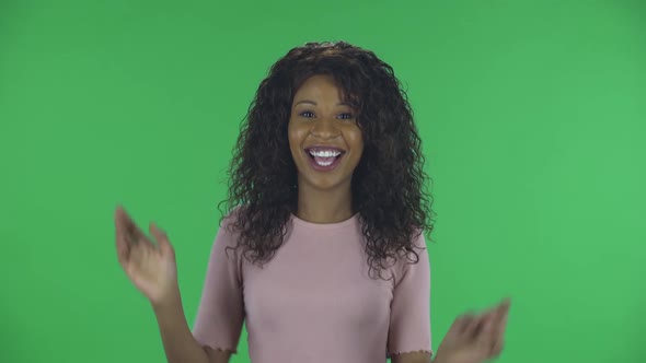 Portrait of Beautiful African American Young Woman Is Looking at Camera and Dancing Funny. Burning