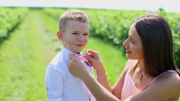 Happy Mother and Her Little Daughter and Son in the Summer Field Happy Family