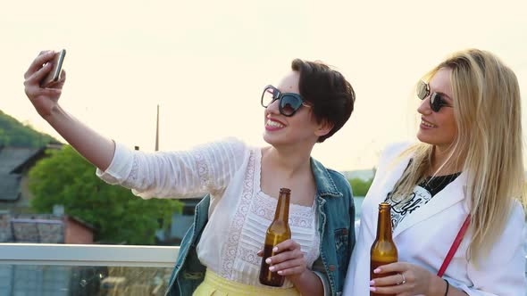 Happy Women Making Photo On Phone Outdoors, Drinking Beer