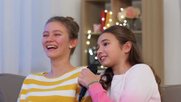 Teenage Girls with Microphone Singing at Home