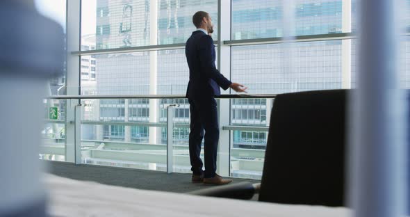 Businessman on smartphone in modern office building