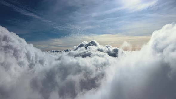 Aerial View From Airplane Window at High Altitude of Earth Covered with White Puffy Cumulus Clouds