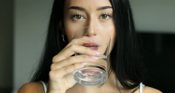 young woman drinking a glass of water