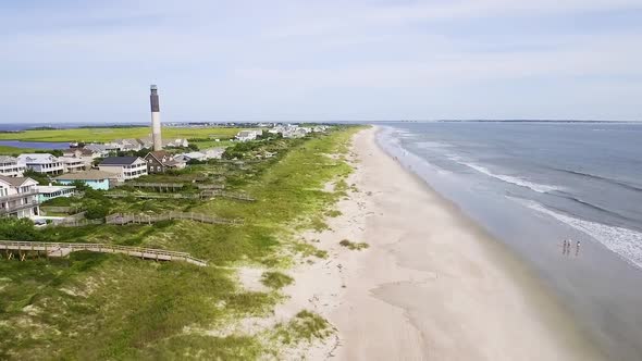 Oak Island lighthouse on a bright sunny day with empty beach